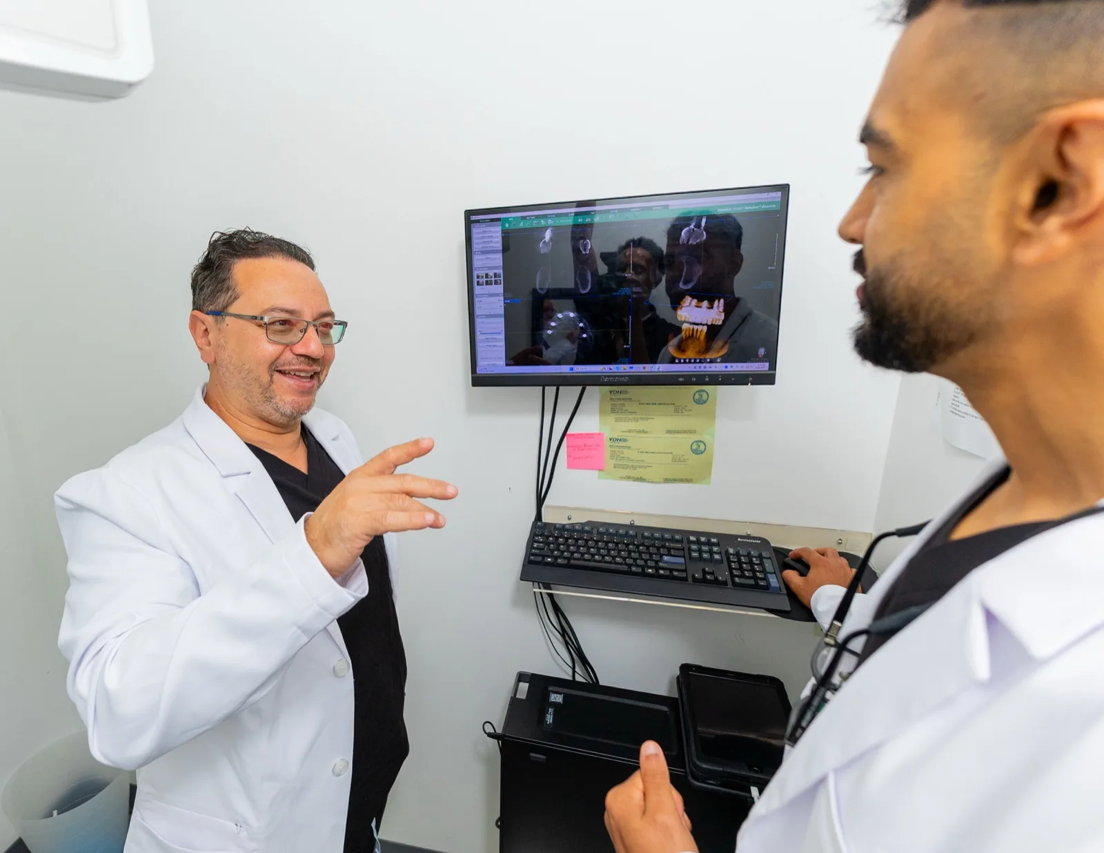 Dr. Arafa and Dr. Waris reviewing a 3D implant scan together